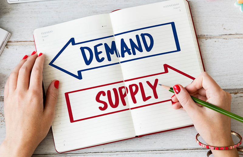 Open notebook showing demand and supply with bold blue and red arrows for navigating 2026 it hardware supply constraints guide