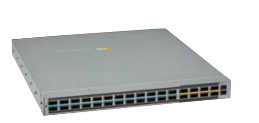 Gray metal arista dcs-7050cx4-24d8-f network switch with 24 200G ports and a yellow sticker on the top surface