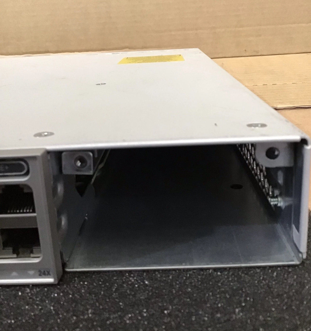Silver metallic cisco c9300-24p-e 24-port gigabit poe+ switch rear view with modular 24-port ethernet switch module