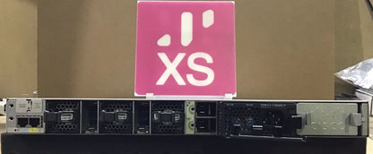 Black cisco c9300-48uxm-a network switch with 48 ports ventilation grilles and pink xs logo sign for multi gig use