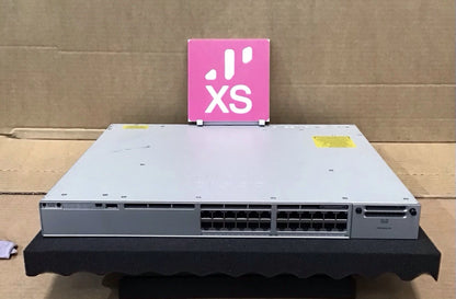 Silver cisco catalyst 9300 24-port gigabit poe plus switch with multiple ethernet ports and yellow warning label on top